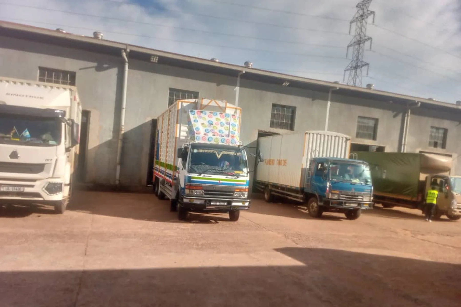 Several Lechon Ventures trucks lined up at the warehouse loading bay