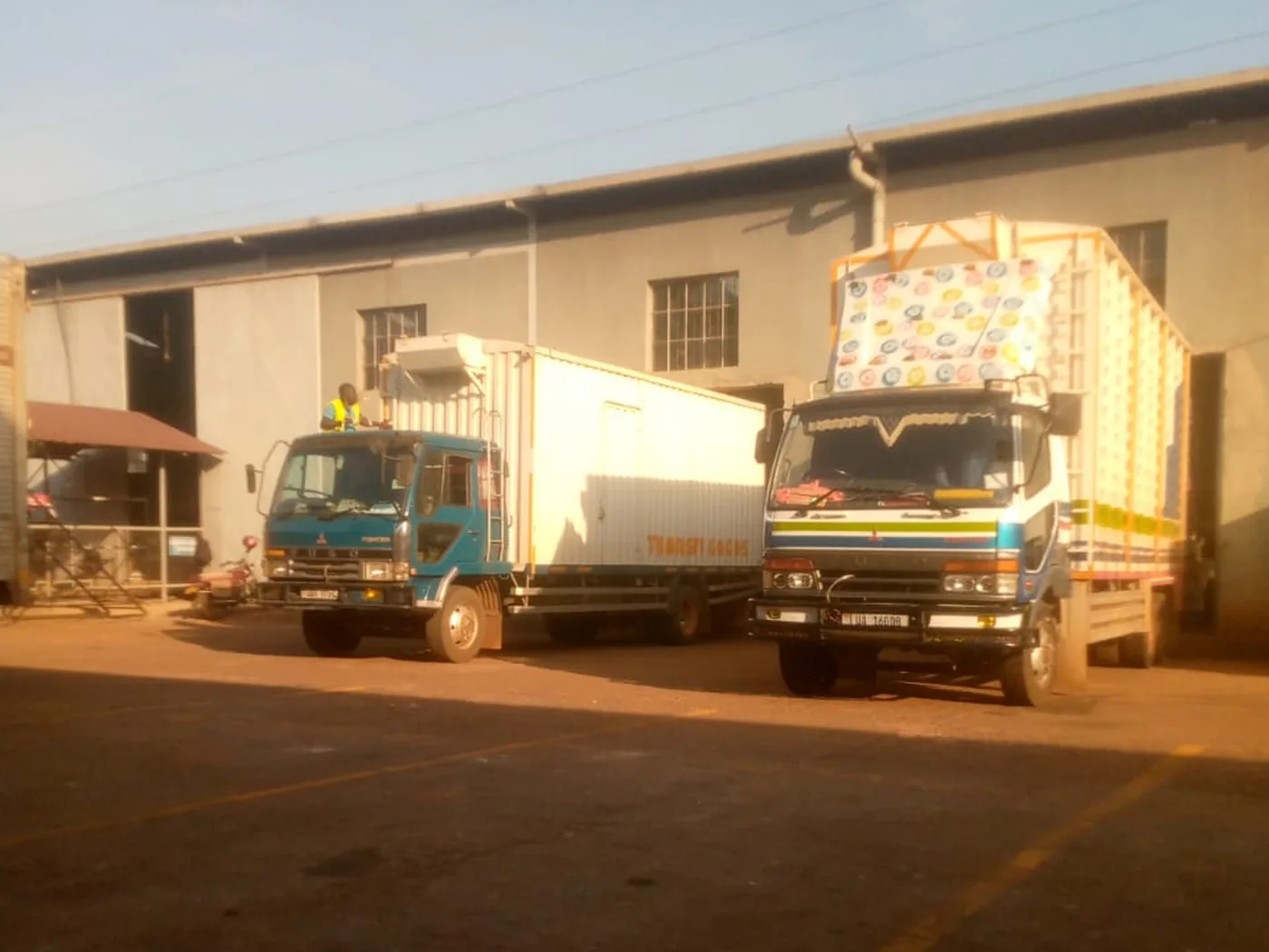 Trucks being loaded at the Lechon Ventures yard in Kampala